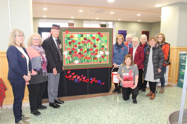 Morrisons community champion Myra Smith, Richard Reade, vice chairman of the Dumfries and Maxwelltown Branch of the Royal British Legion and some of the Solway Quilters
