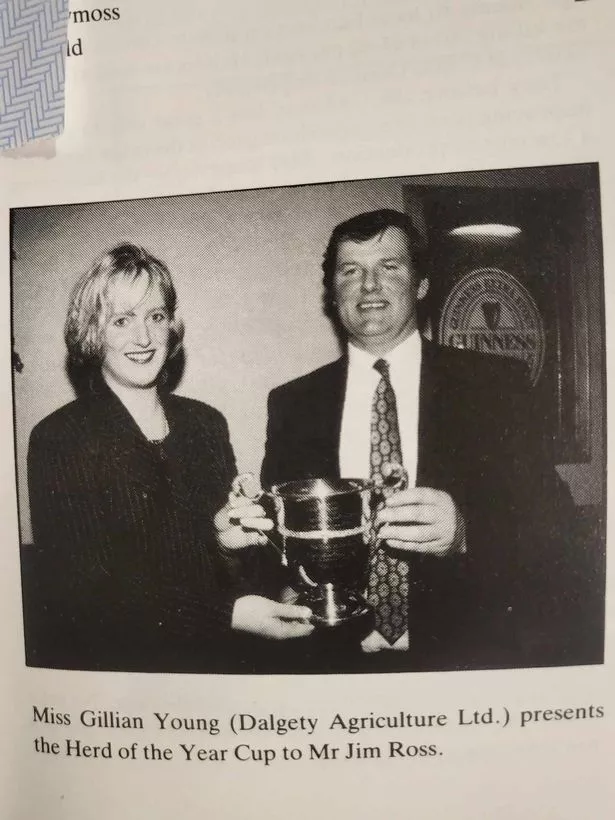 Gillian Young of Dalgety Agriculture Ltd presenting Jim with his herd of the year trophy in 1994