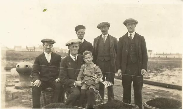 Shaun’s great-grandad Martin McGuire with his four sons taken on the Isle harbour