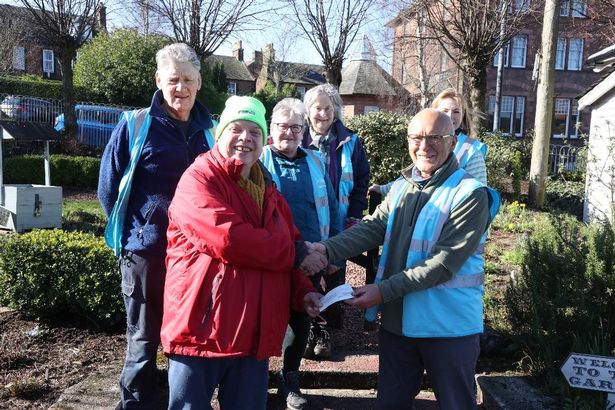 Simon Jones, secretary of Loreburn Community Council, hands over a £380 contribution to help Dumfries Adoptive Railway Gardeners