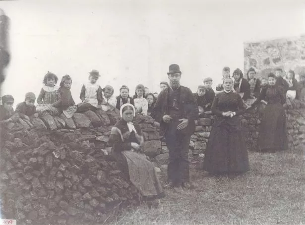 Scoraig Public School in 1897. Mary Ann Mackenzie is the third child on the left, sitting on the wall